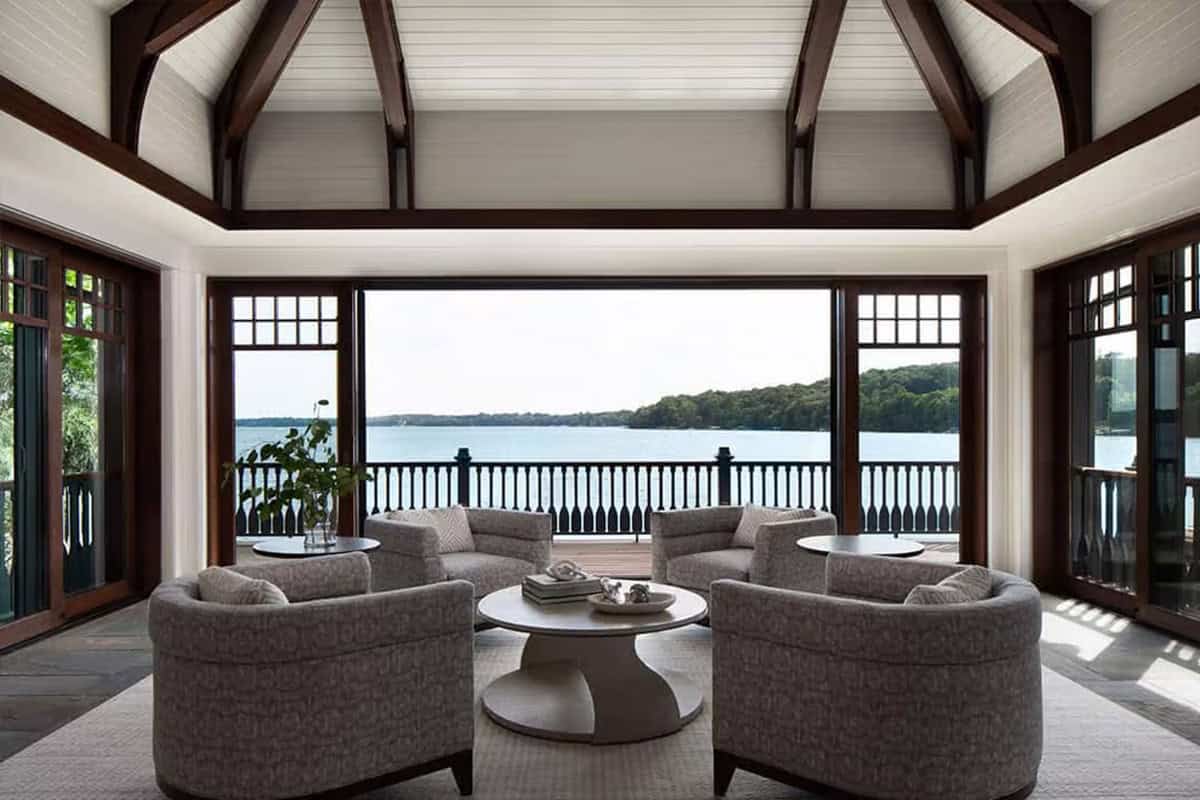 Boathouse sitting room with glass doors open to the lake deck