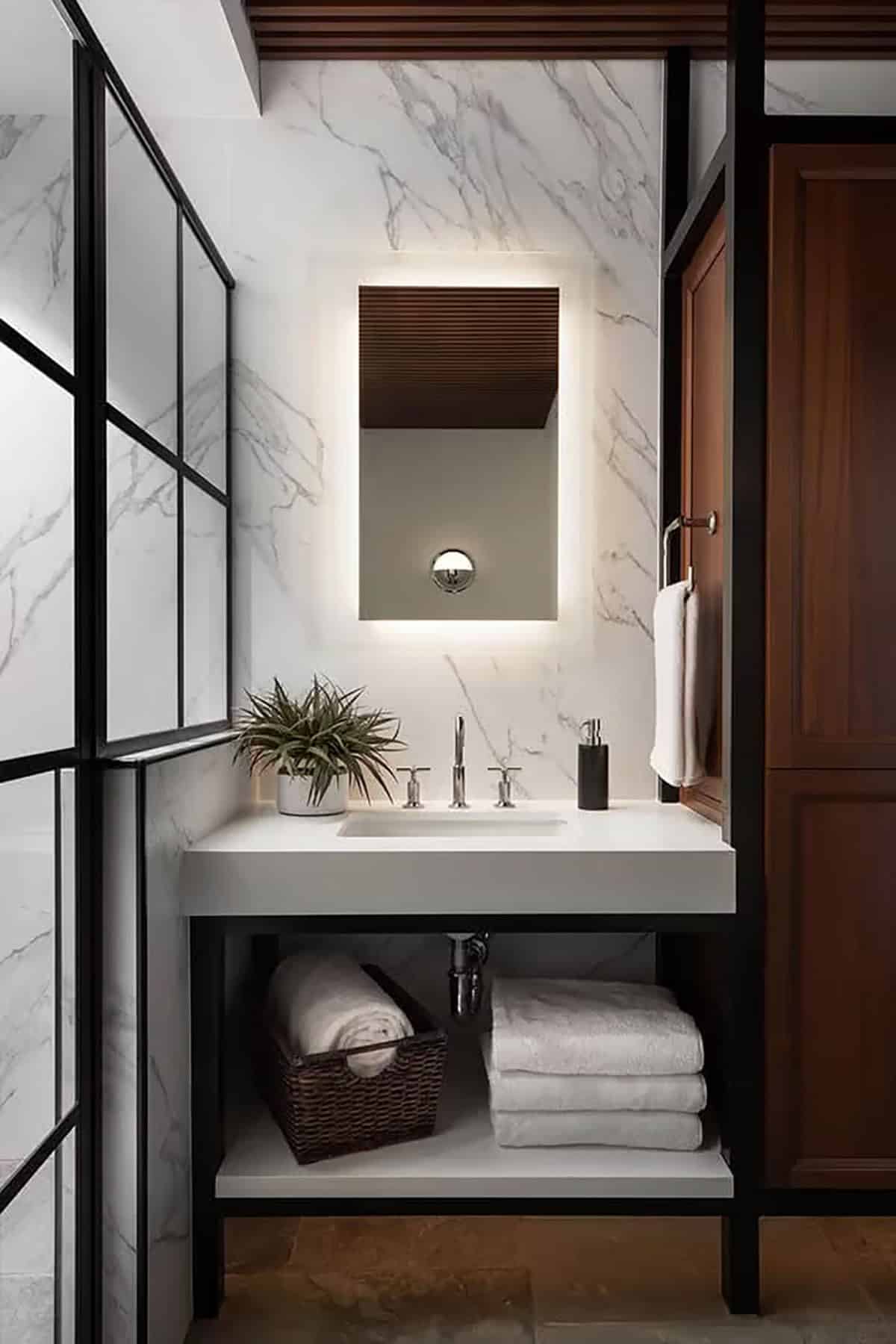 Marble bathroom with backlit mirror and open vanity