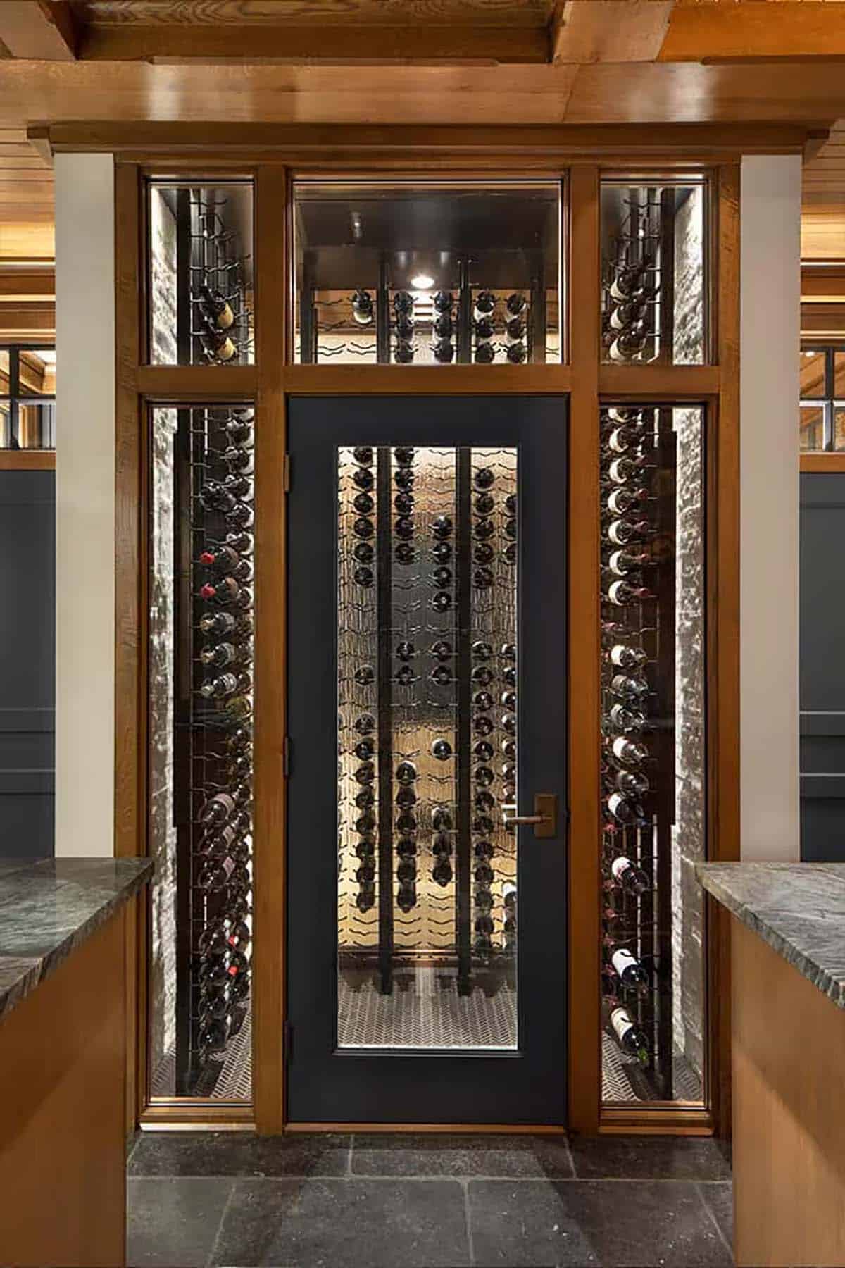 Glass-front wine room with navy door and oak trim