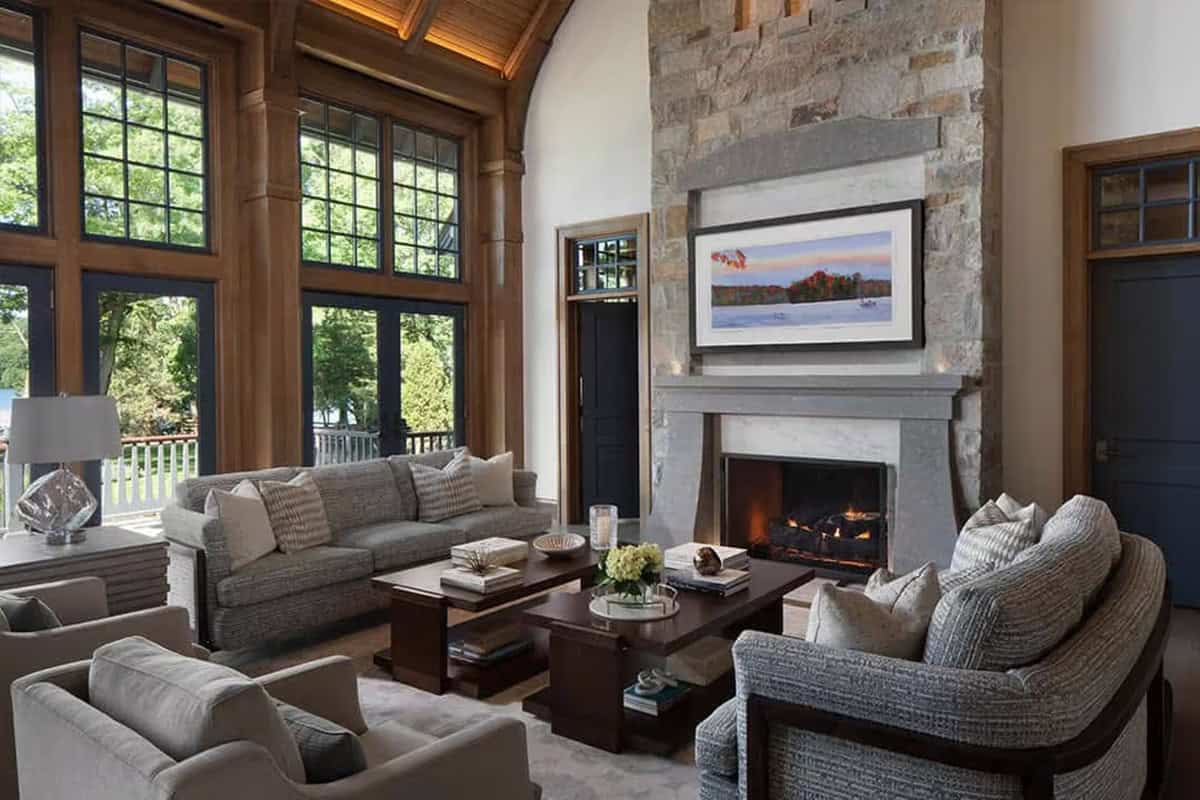 Great room with stone fireplace, textured sofas and tall windows