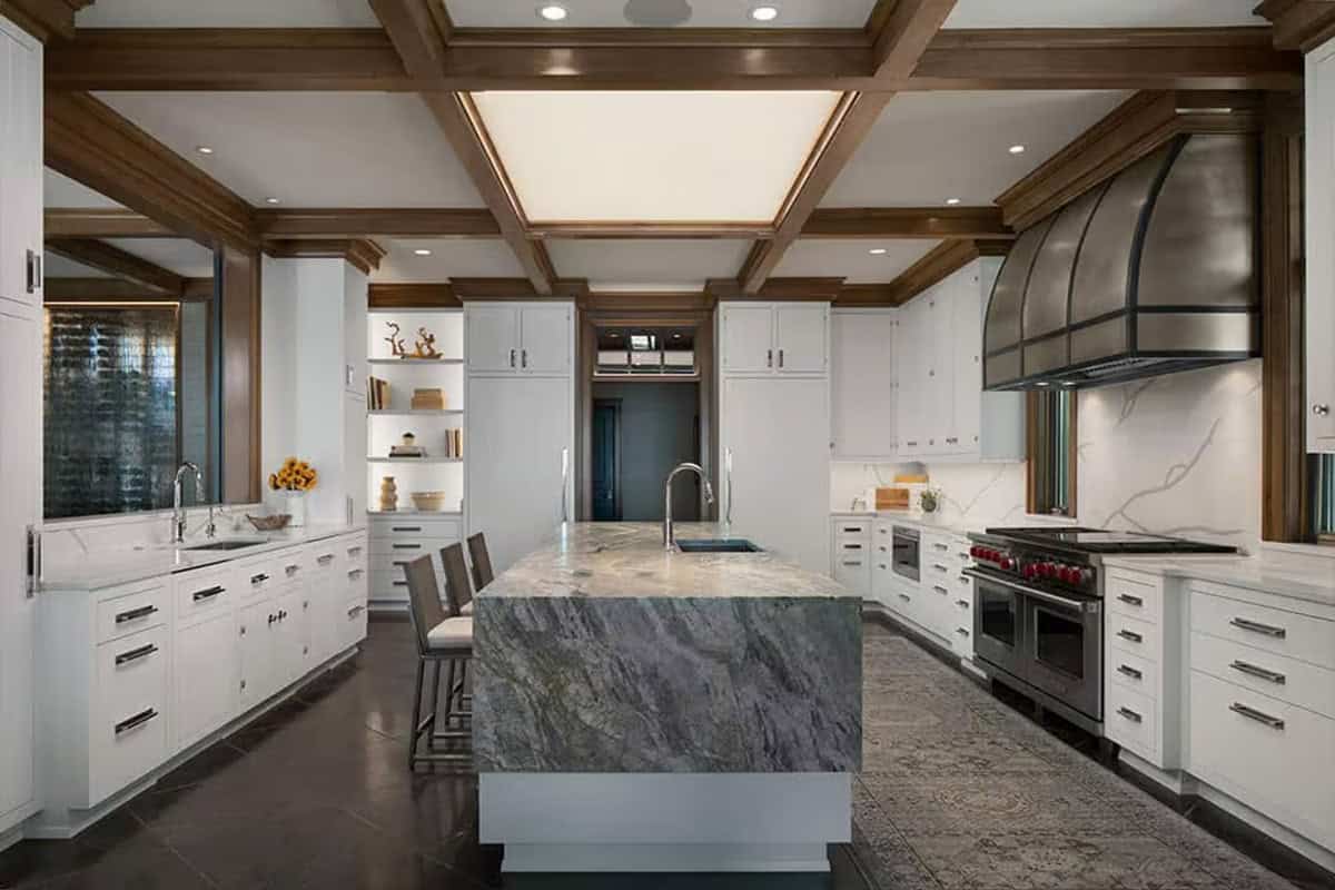 White cabinet kitchen with coffered ceiling and dripping countertop island
