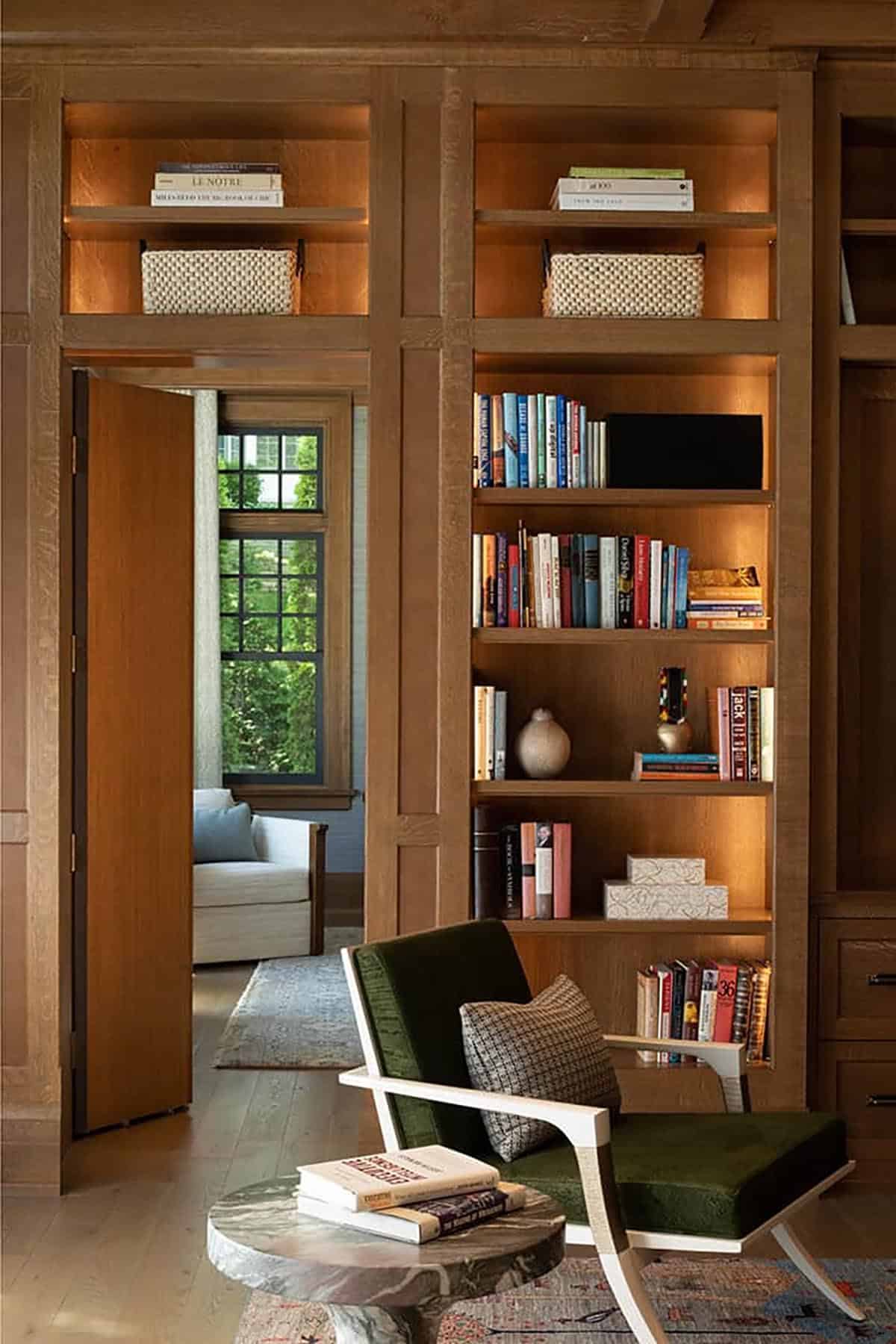 Hidden door in oak library paneling opening to a secret room