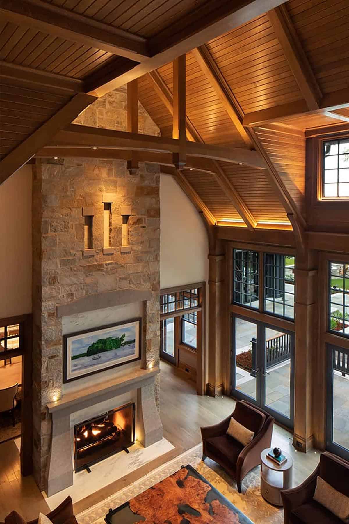 Overhead view of great room with stone fireplace and timber ceiling