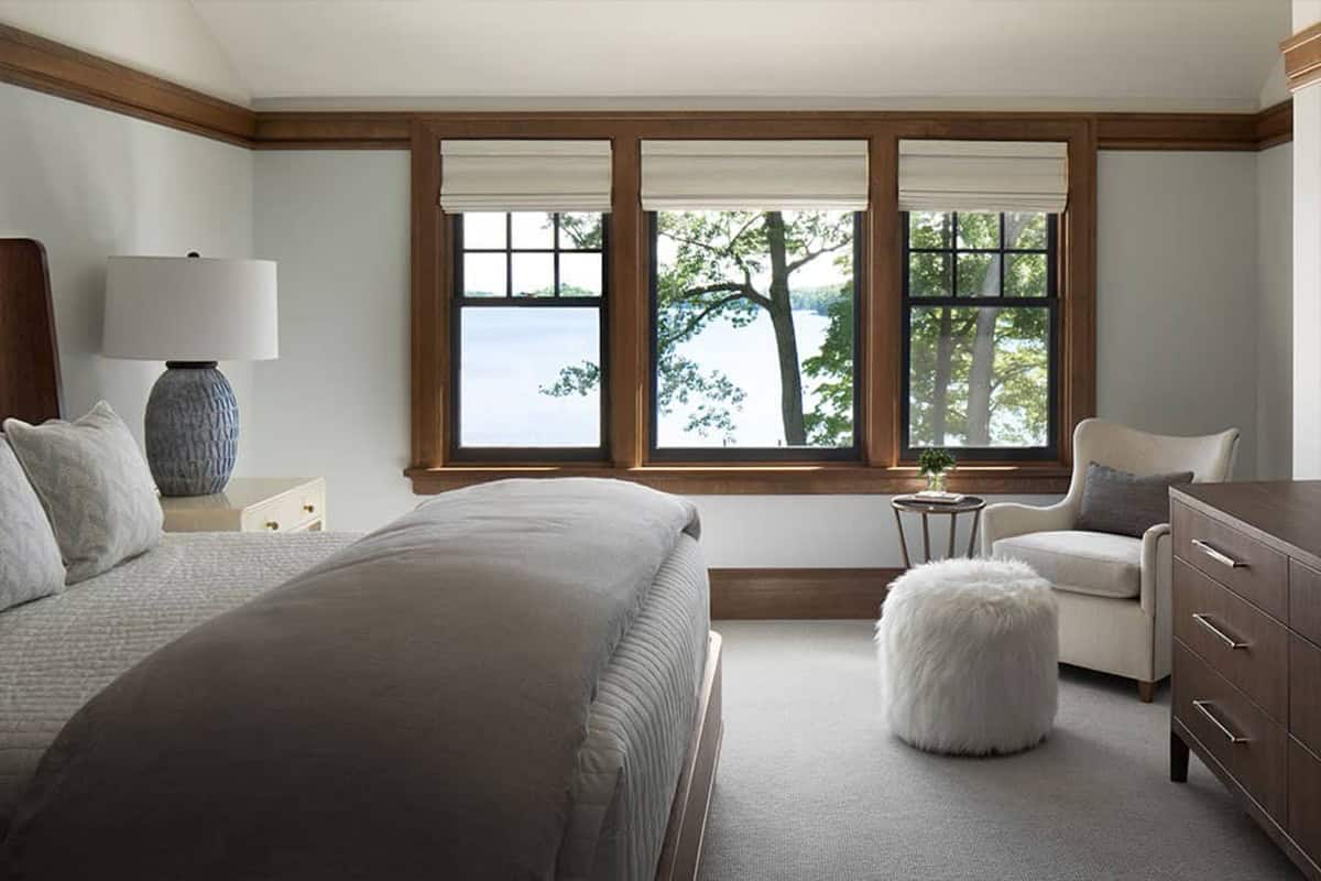 Guest bedroom with three windows overlooking the lake