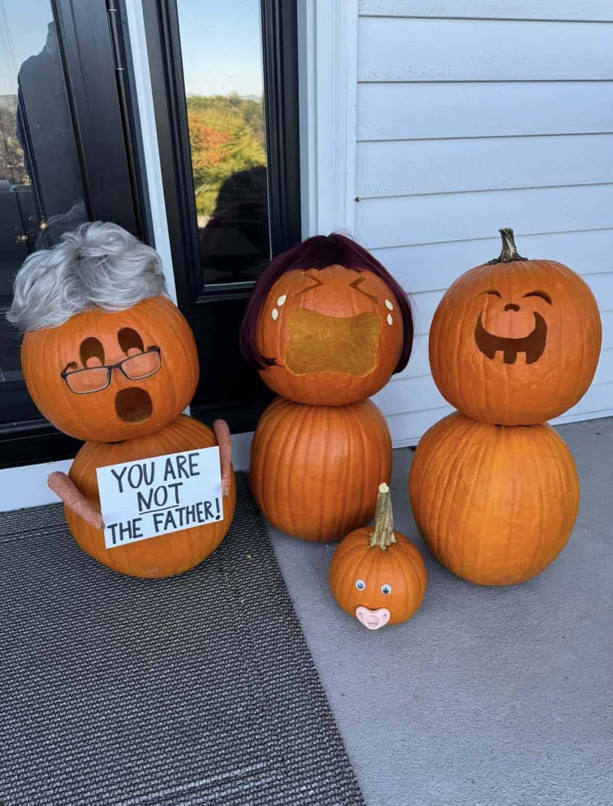 stacked pumpkin family parodying a talk show, with a silver-haired host holding a You are not the father sign, a crying mom, a laughing dad and a baby pumpkin with a pacifier