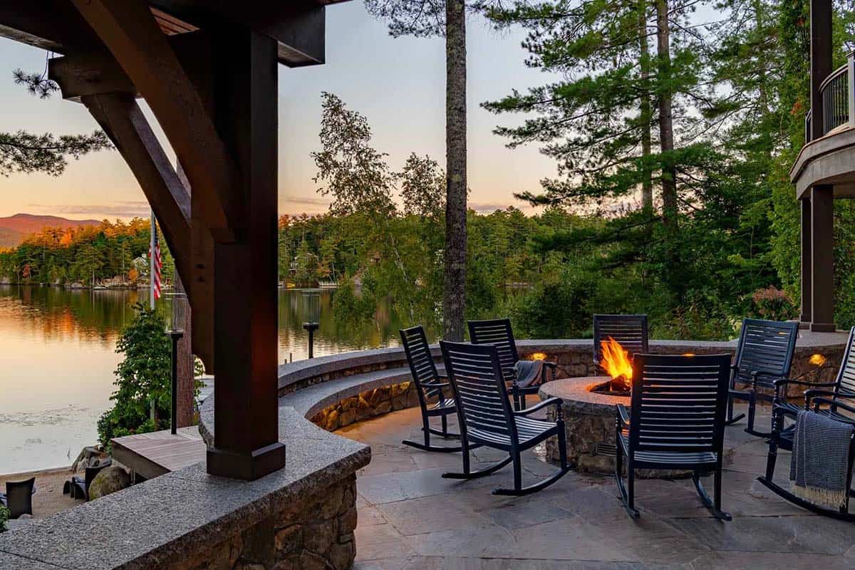 Fire pit terrace with rocking chairs and lake views at sunset
