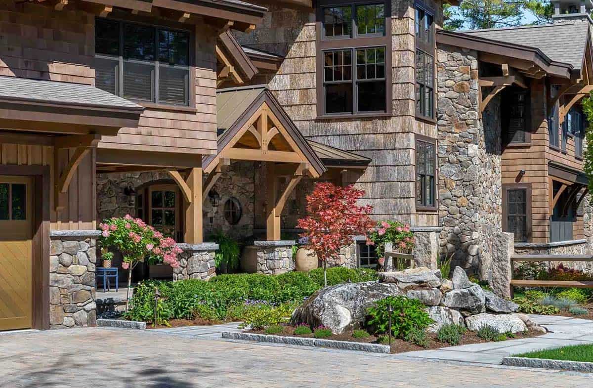Front facade with cedar shingles, fieldstone, timber portico, and a red Japanese maple