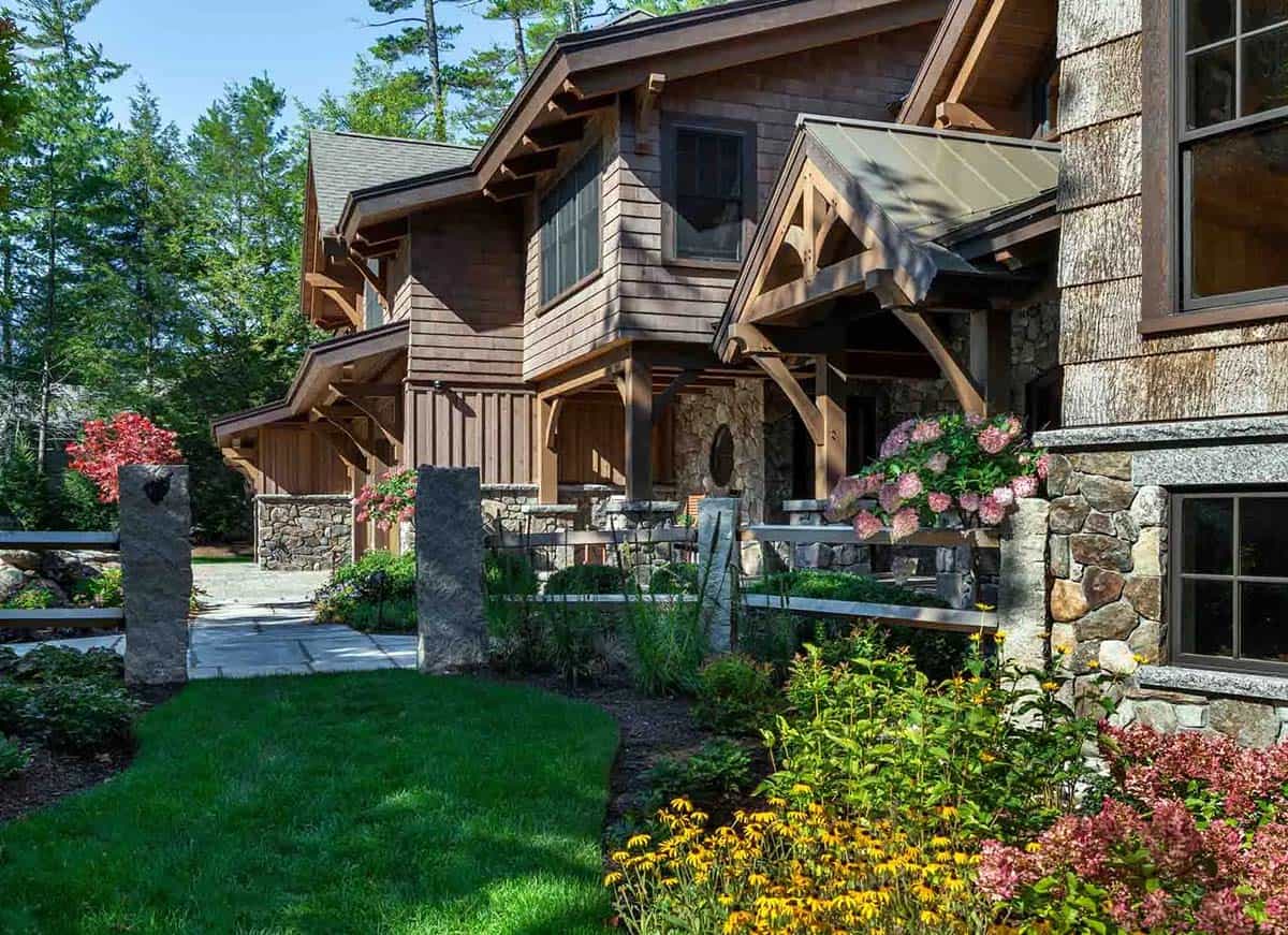 Side garden path with granite posts, black-eyed Susans, and hydrangeas beside the shingled lodge