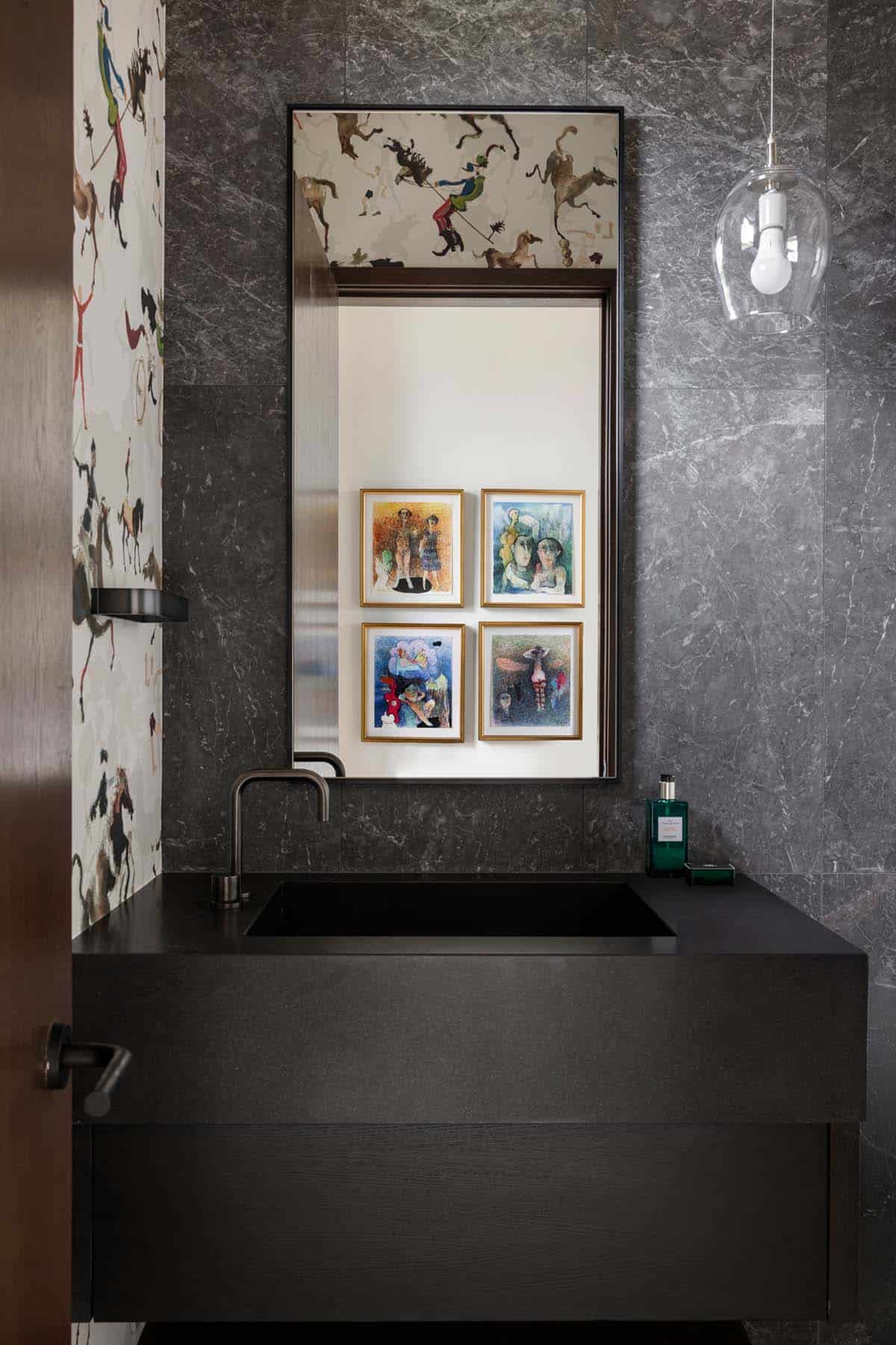 Powder room with gray marble walls, black stone sink, and equestrian wallpaper