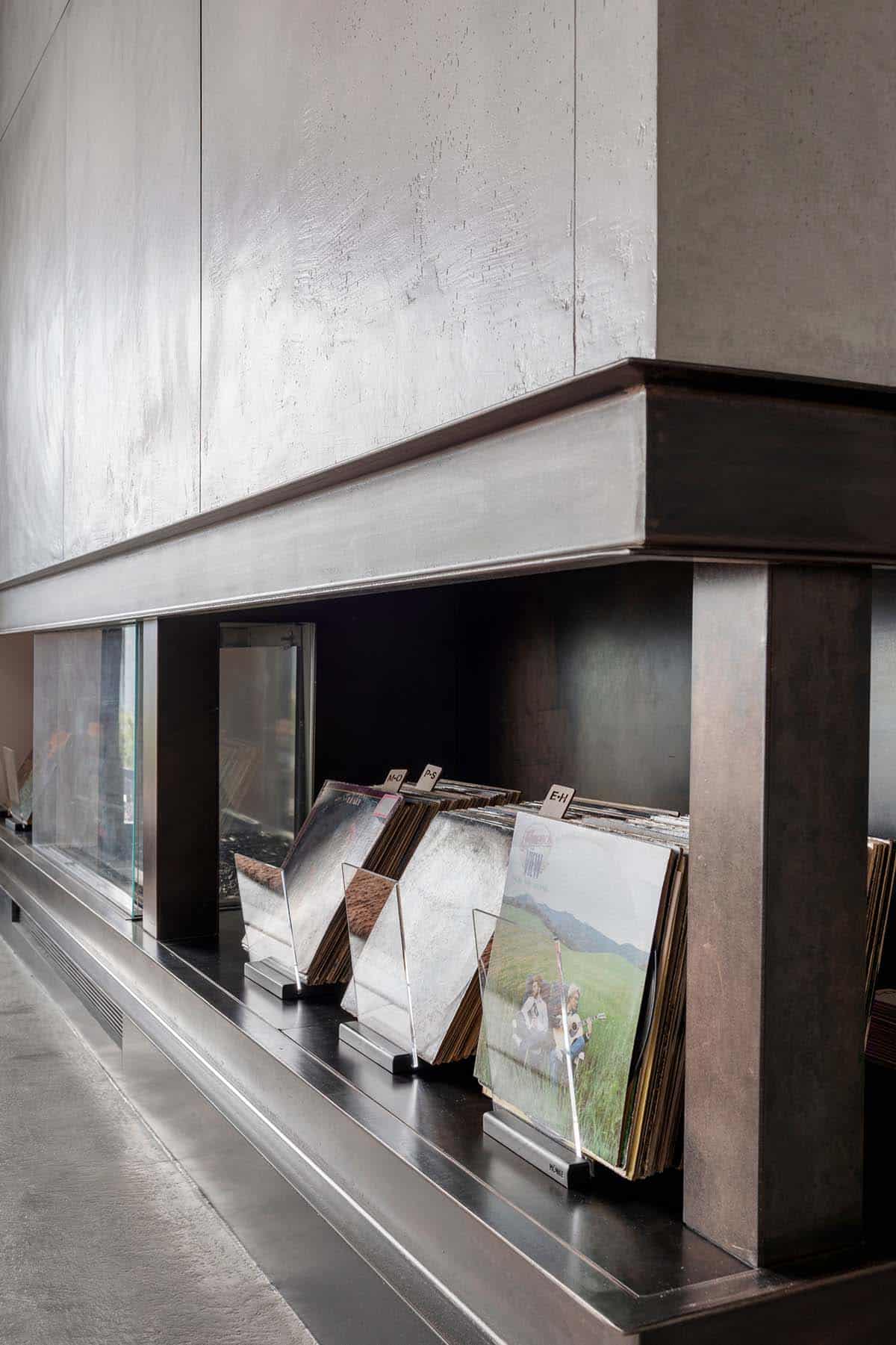 Plaster fireplace surround with vinyl record storage in blackened steel niche