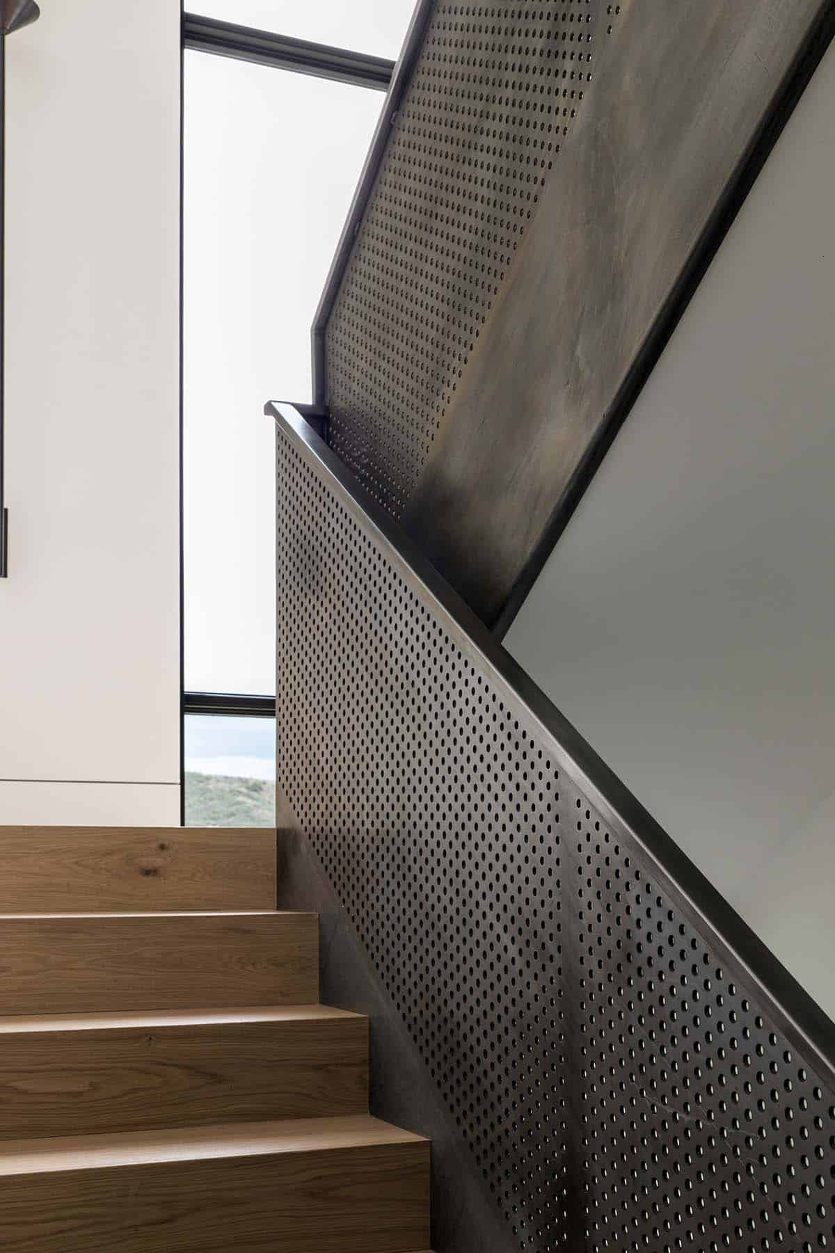 White oak stair treads with perforated blackened steel railing