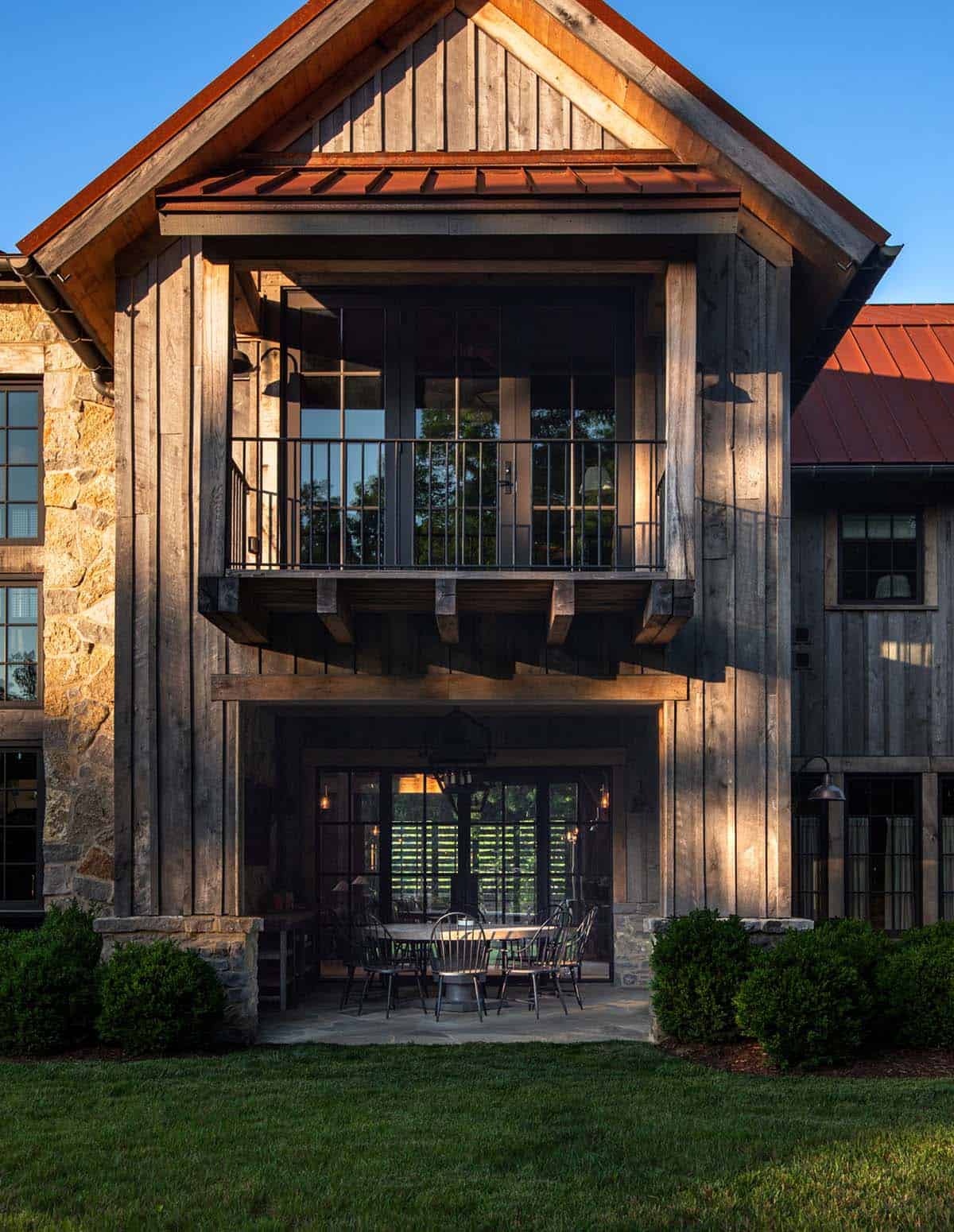 Cantilevered balcony above a covered outdoor dining porch