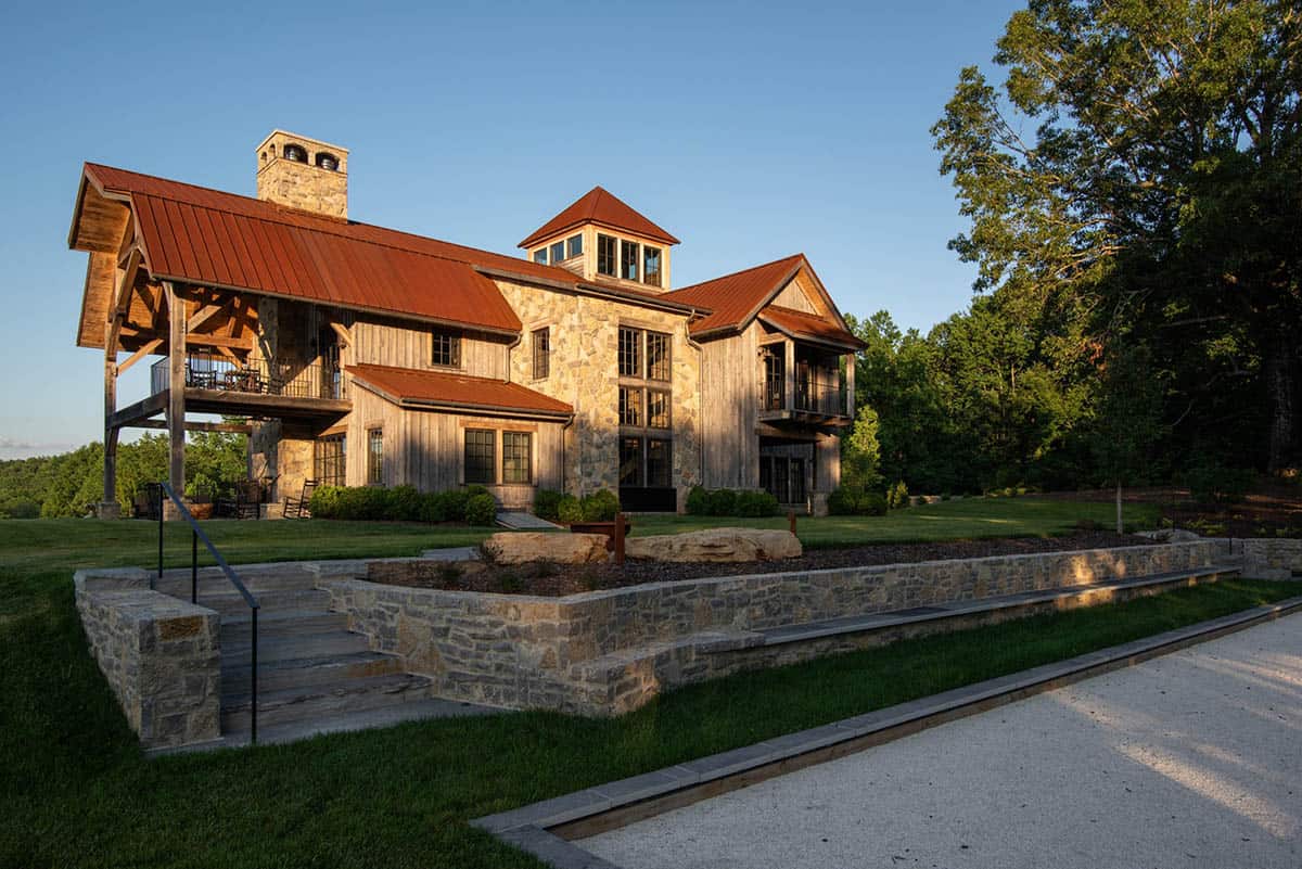 Stone and wood home with timber porch above a bocce court