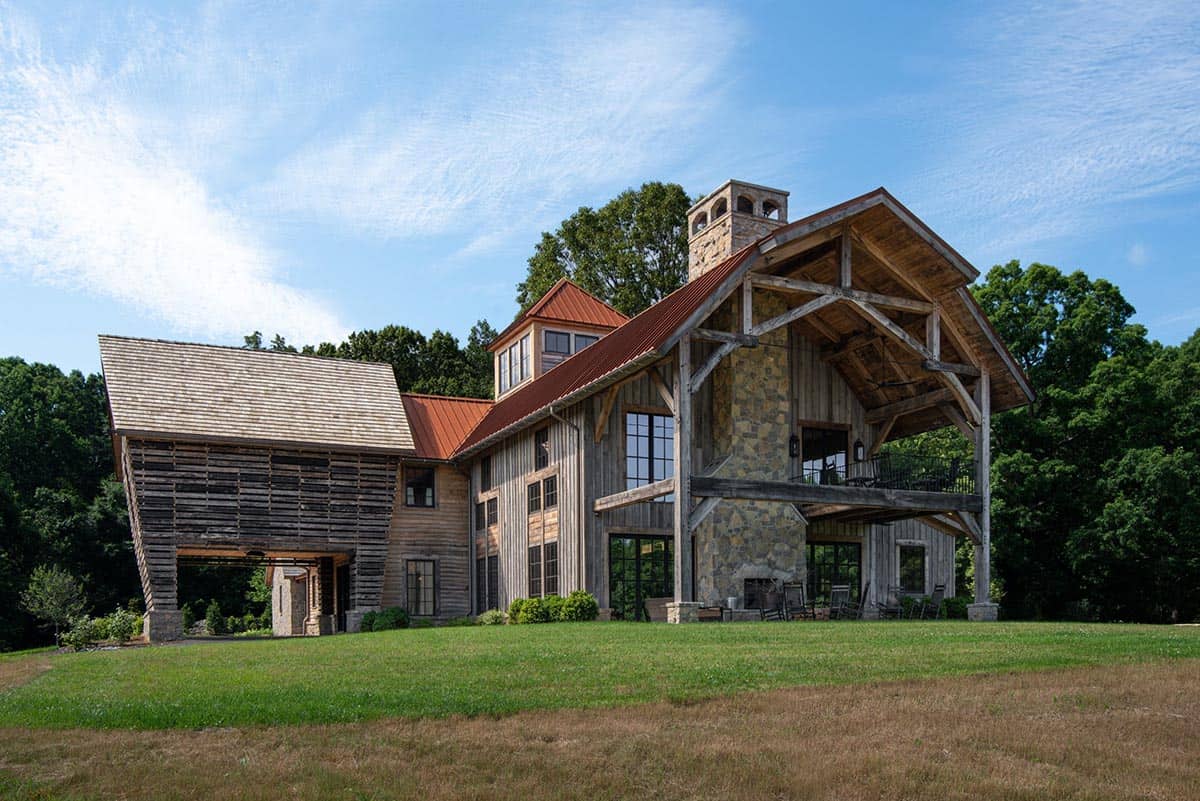 Corn crib-inspired entry and double-deck timber porch on a lawn