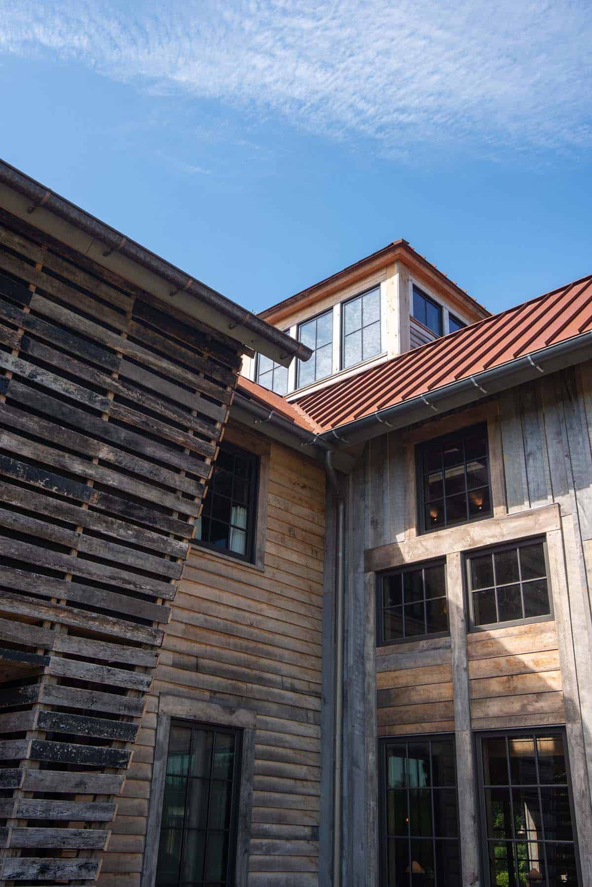 Slatted reclaimed wood siding meeting board-and-batten below cupola