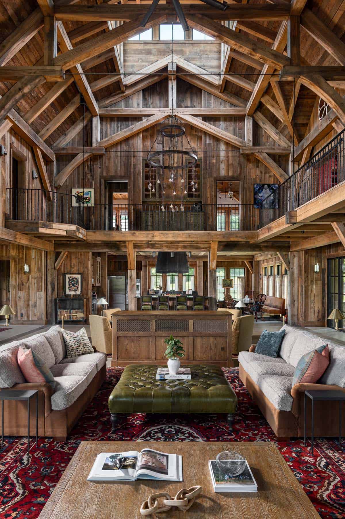 Great room with tufted green leather ottoman and Persian rug