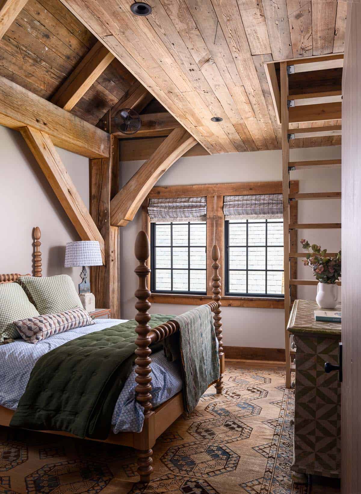 Guest bedroom with spool four-poster bed and wooden loft ladder