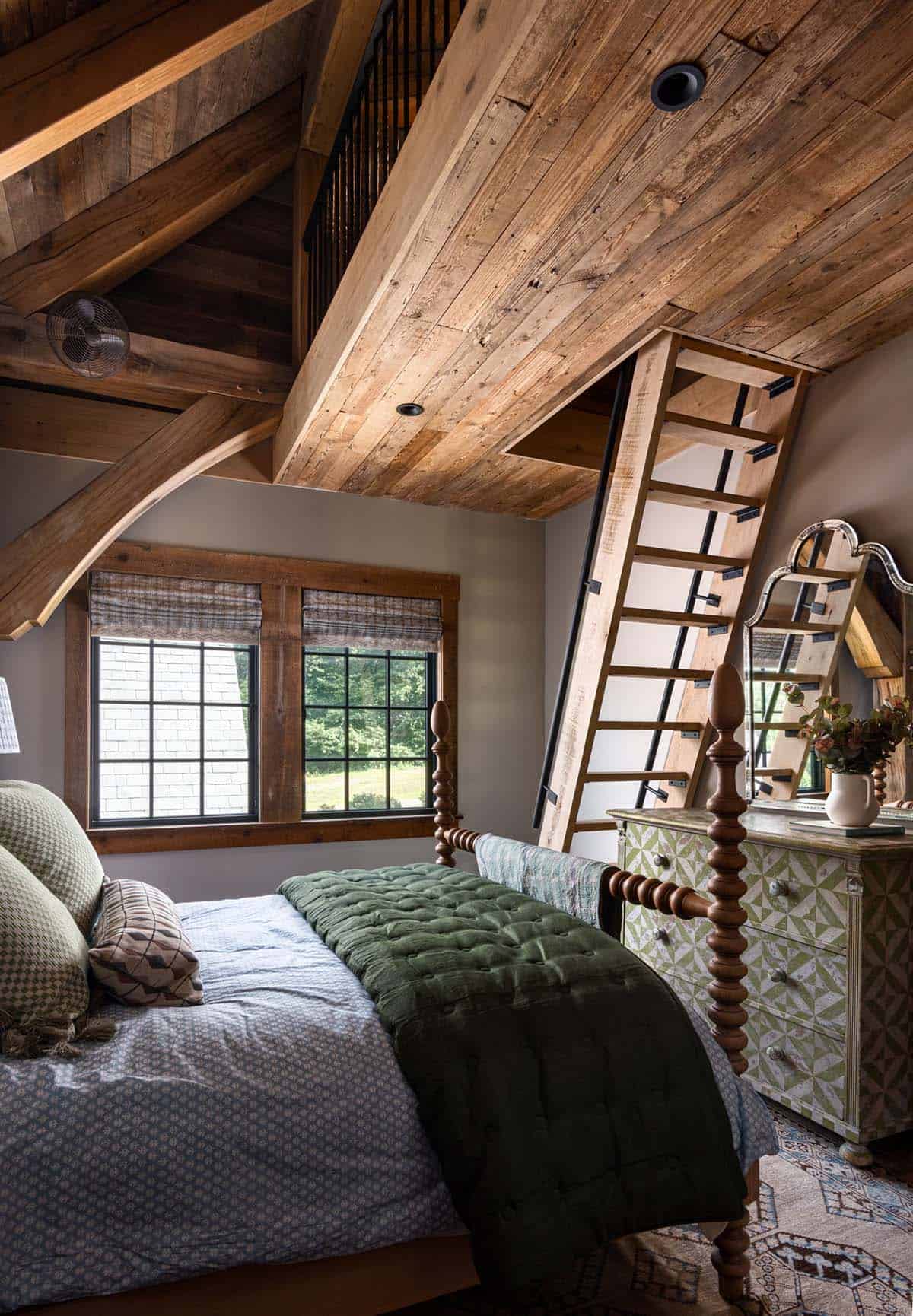 Loft ladder rising above spool bed and painted geometric dresser