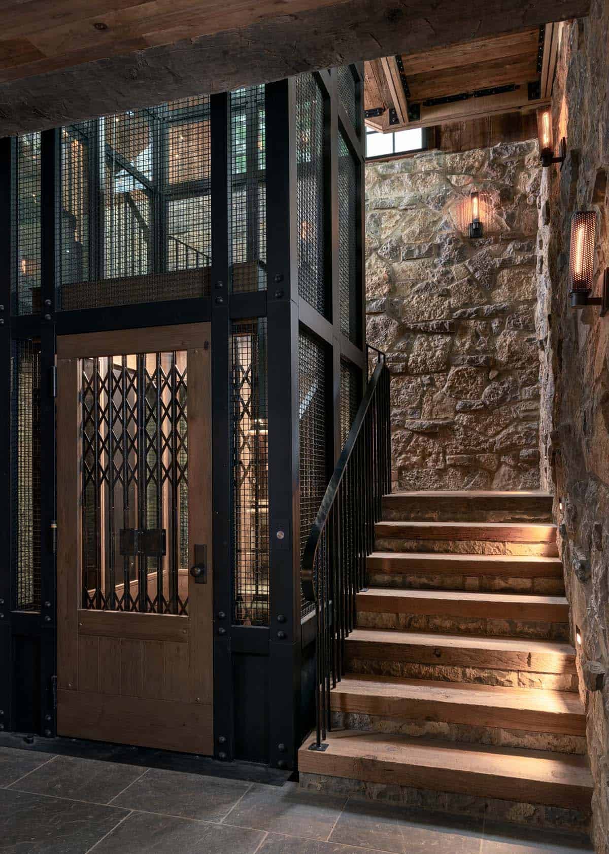 Mesh elevator with scissor gate beside stone stairwell