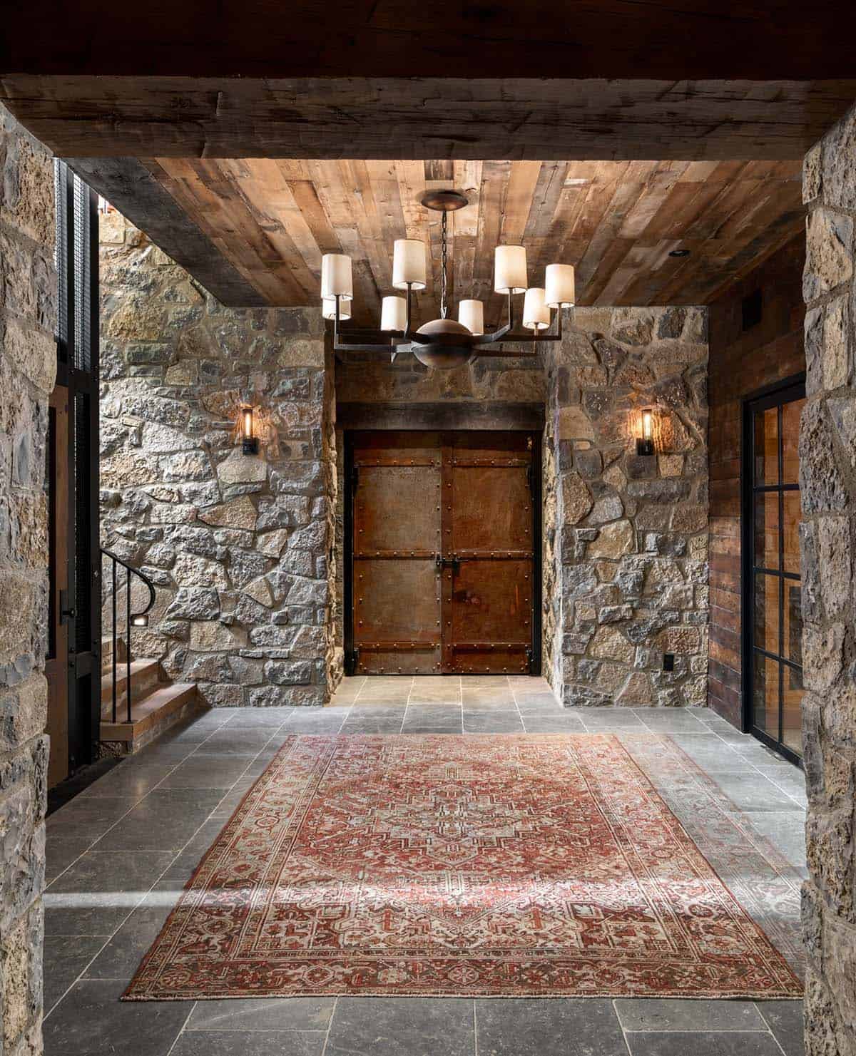 Lower-level vestibule with antique iron-clad doors and Persian rug