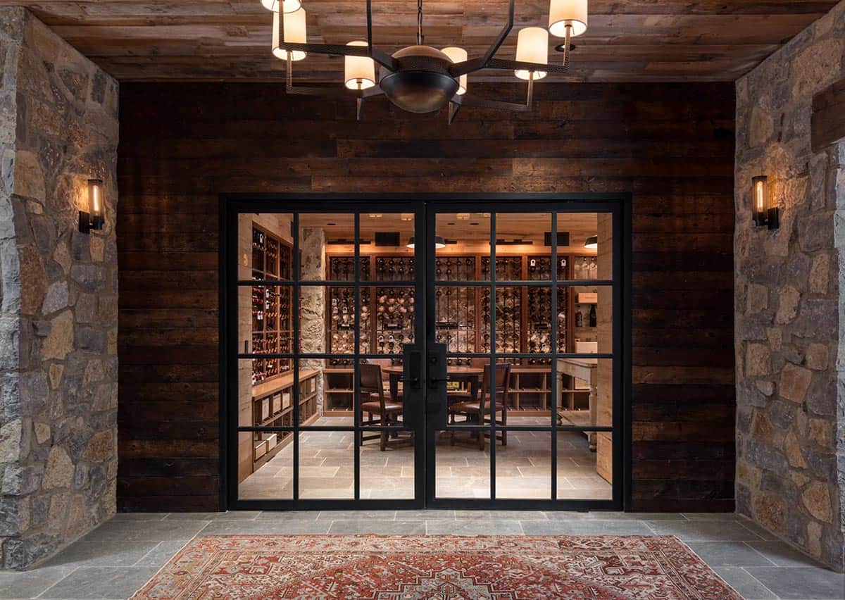 Steel doors opening to wine cellar with tasting table