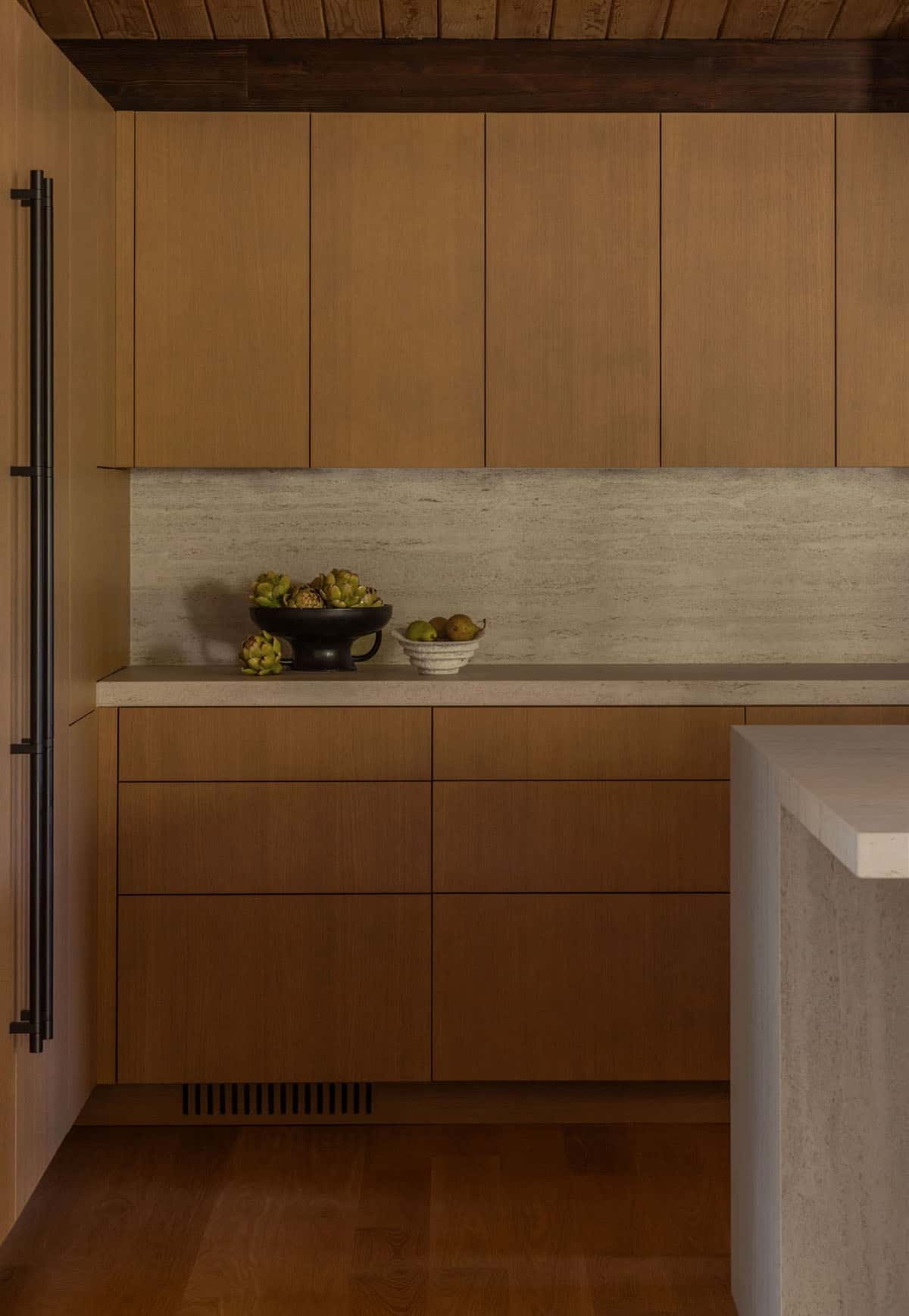 Flat-front oak cabinets with stone-look backsplash and countertop
