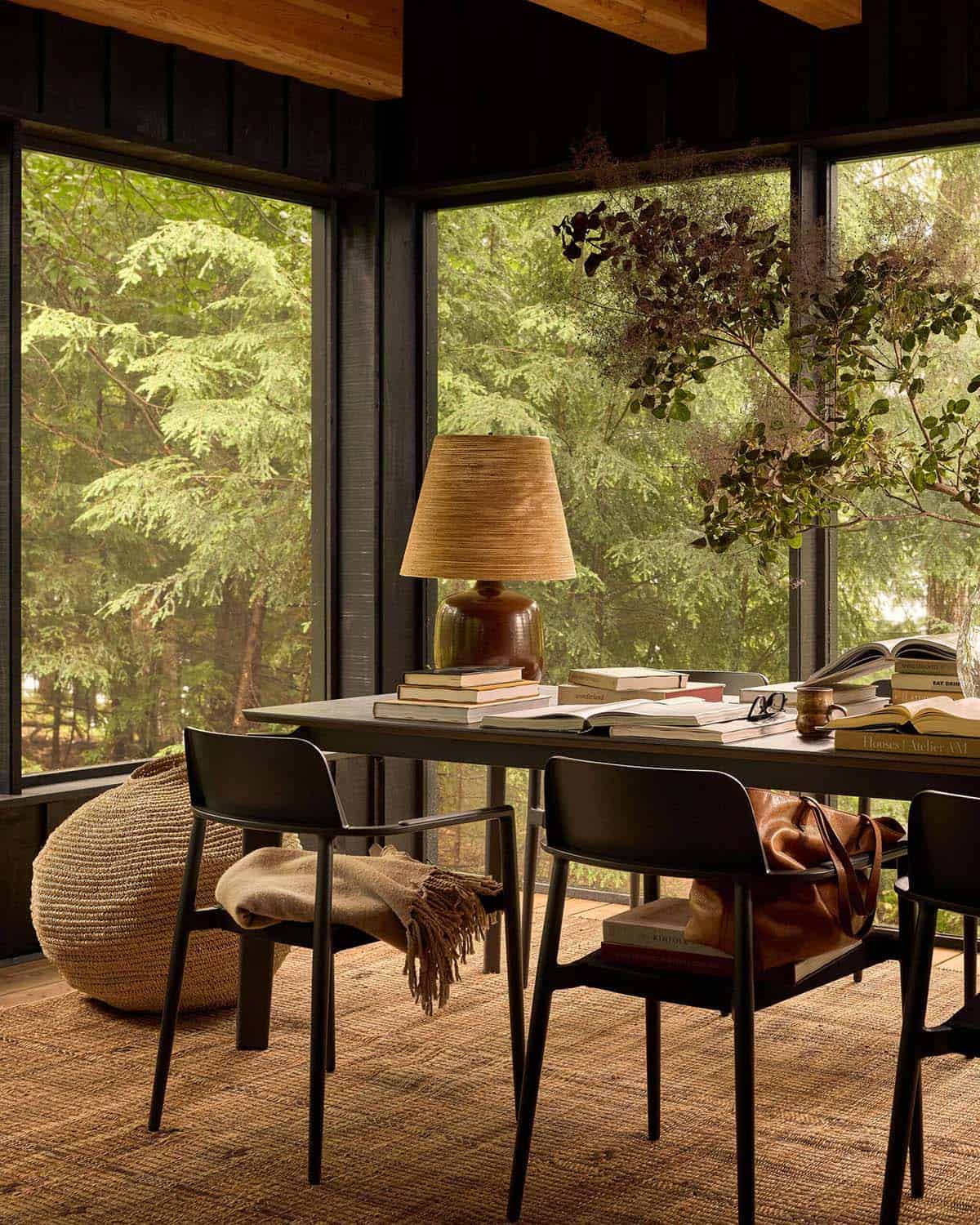 Screened porch dining table with ceramic lamp and forest views