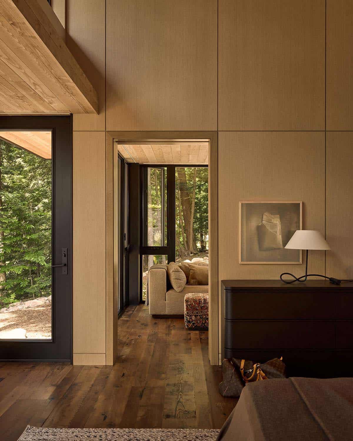 Ash-paneled bedroom with doorway to a sitting room