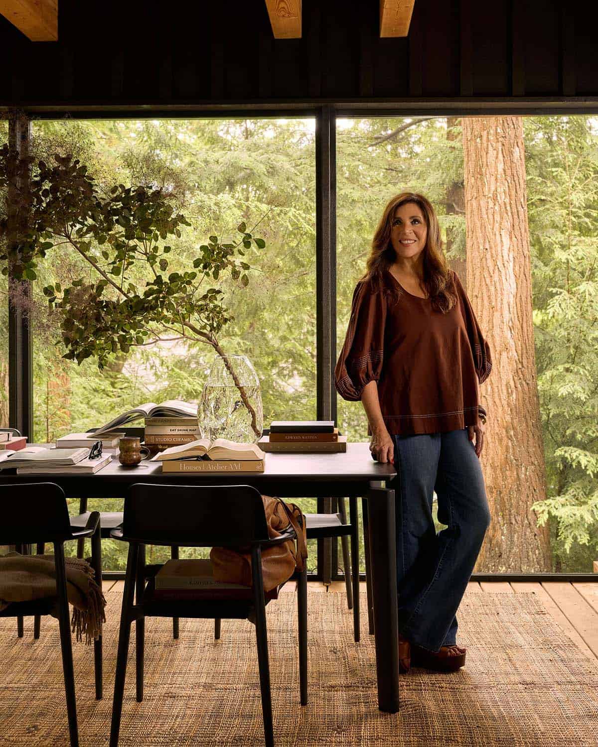 Woman standing beside the screened porch dining table