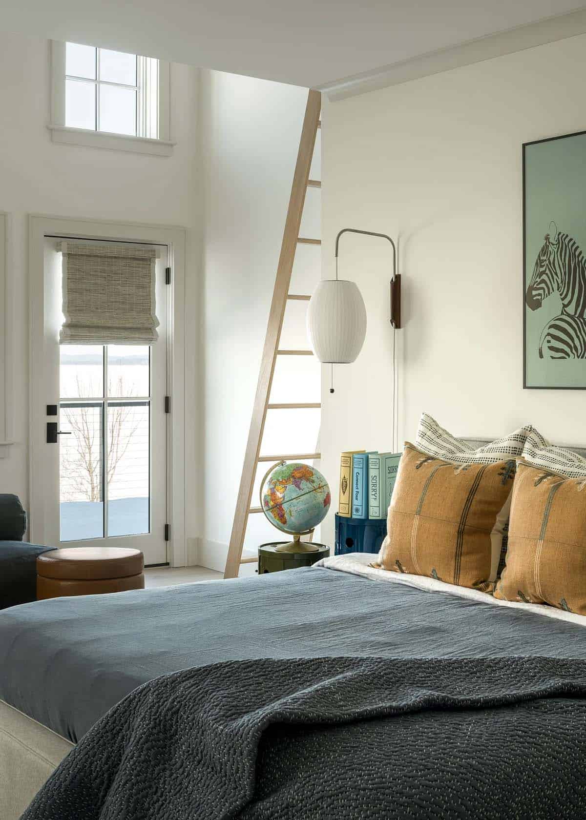 Bedroom with ladder to a sleeping loft, Nelson bubble wall sconce, and glass door to a lake-view balcony