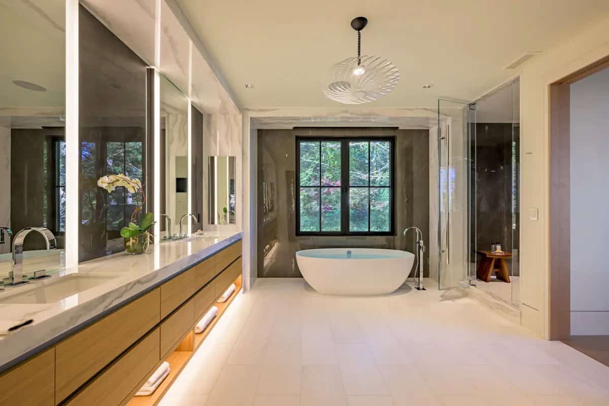 Primary bathroom with a freestanding tub, floating oak double vanity, and a glass-enclosed shower