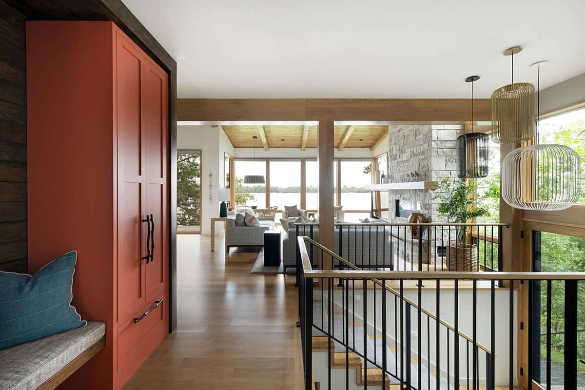 View from the entry past the coral cabinet to the living room and lake beyond