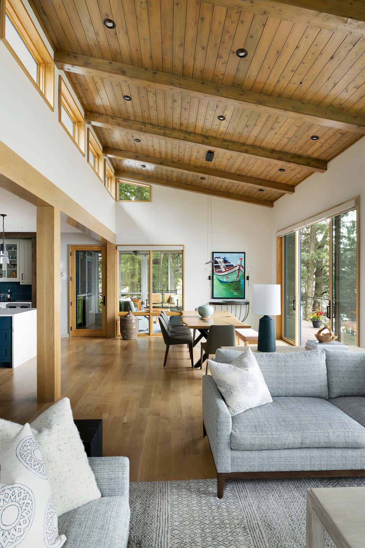 living and dining area with a view through the open door to the screened porch