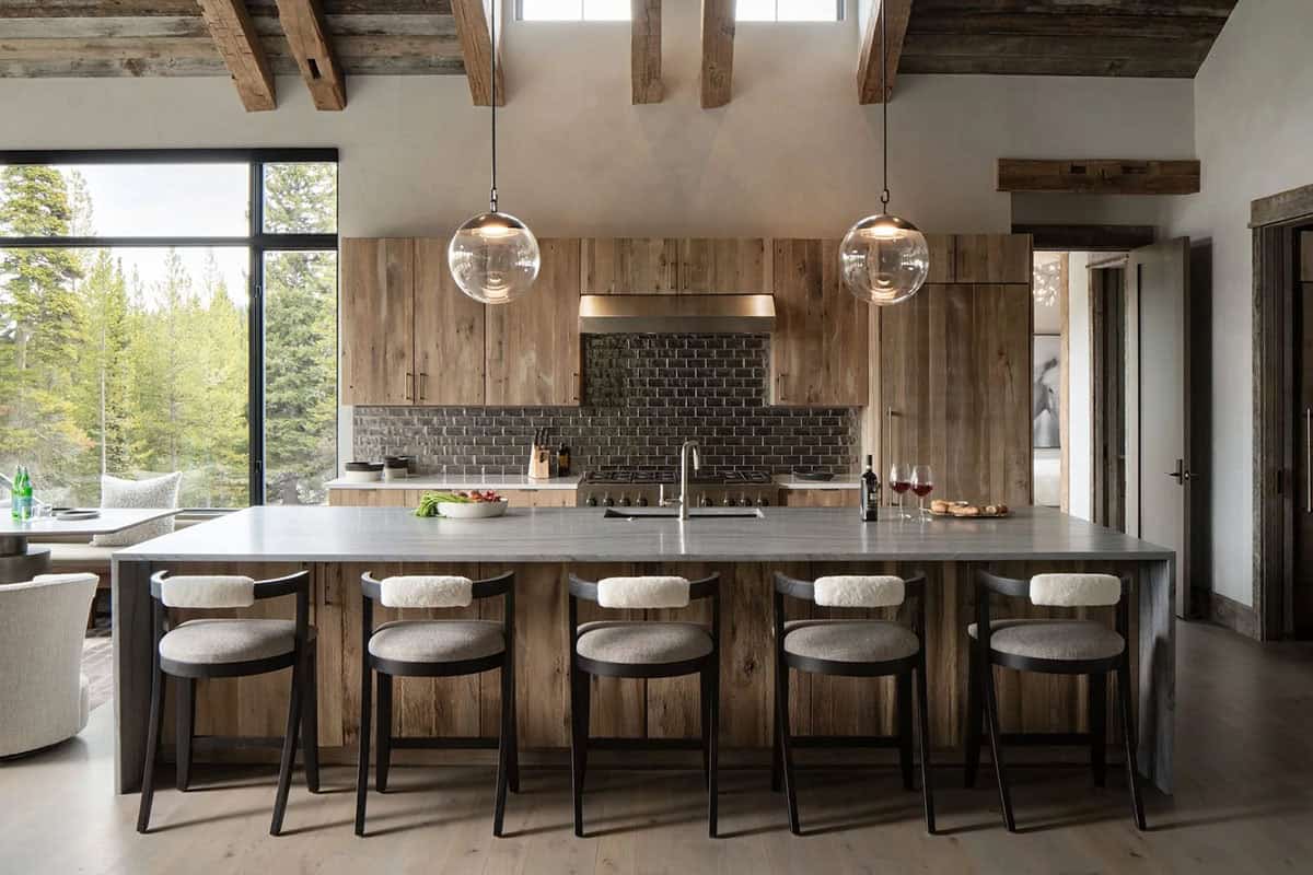 Kitchen with reclaimed wood cabinets, glass globe pendants, and a long island