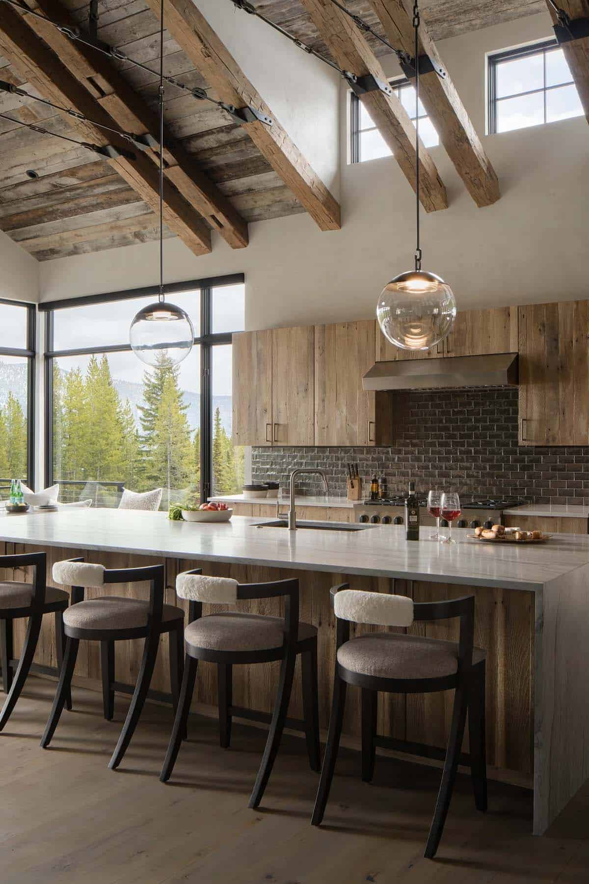 Kitchen island with shearling-back stools under hand-hewn timber beams