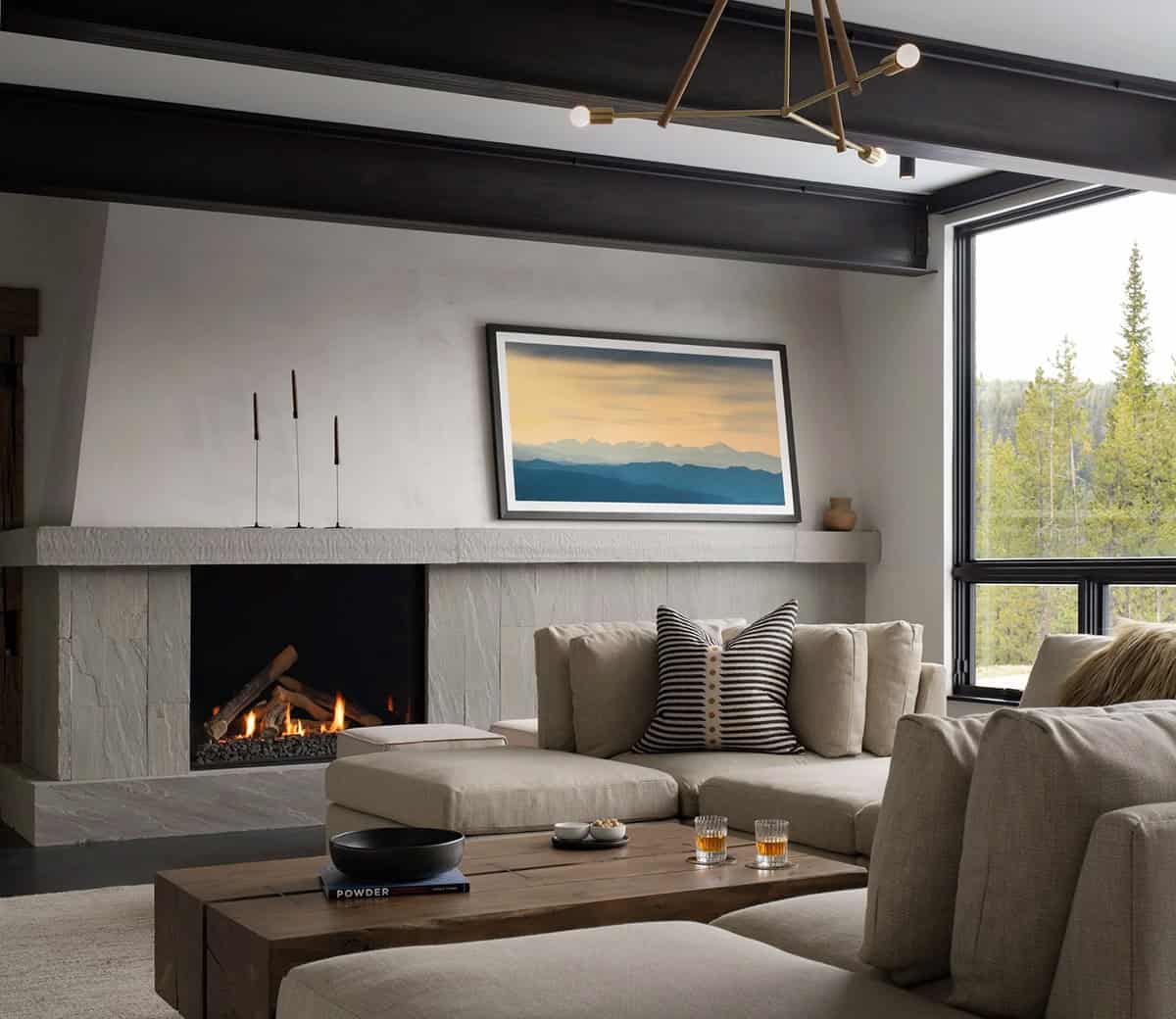 Game room with a stone fireplace, sectional, and timber coffee table