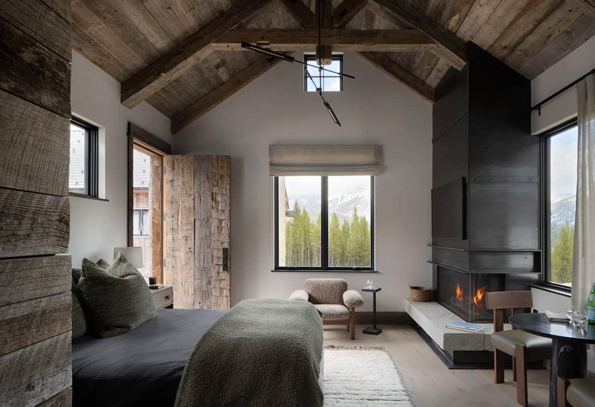 Vaulted guest cabin with a blackened steel fireplace and mountain view