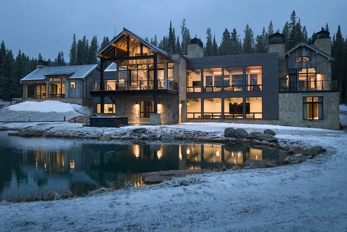 Back of the mountain home at dusk reflected in a pond