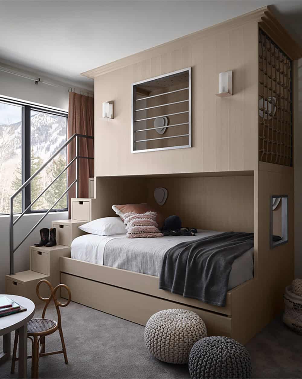 Child's bedroom with a built-in loft bed, storage steps, rope-net railing, and a mountain view