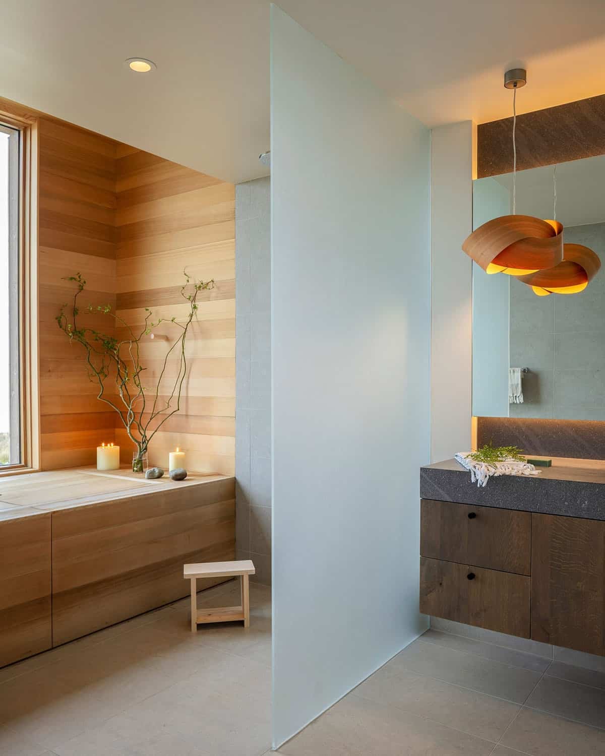 Bathroom with a cedar-lined soaking tub, frosted glass partition, floating vanity, and a sculptural wood pendant