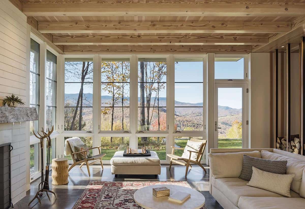 Living room with floor-to-ceiling windows framing mountain views