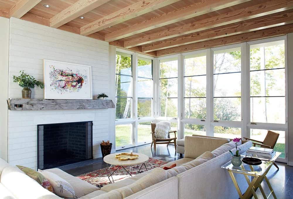 Living room with painted brick fireplace and a reclaimed timber mantel