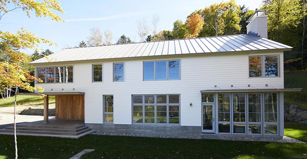 Front facade with metal roof, cedar-clad entry and wide timber steps