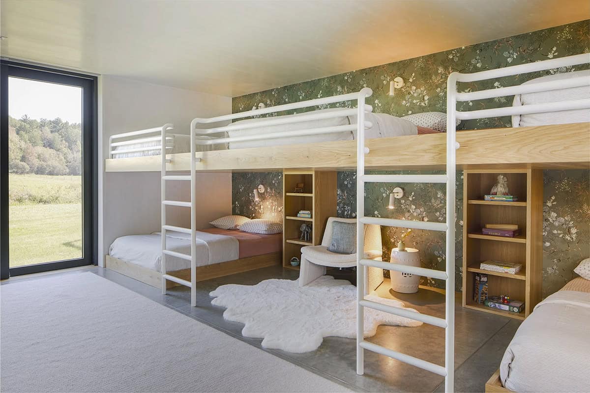 Bunk room with built-in white and oak bunk beds and botanical wallpaper