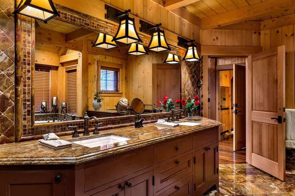 Bathroom double vanity with onyx countertop, mosaic-framed mirror and a row of mica bell pendant lights