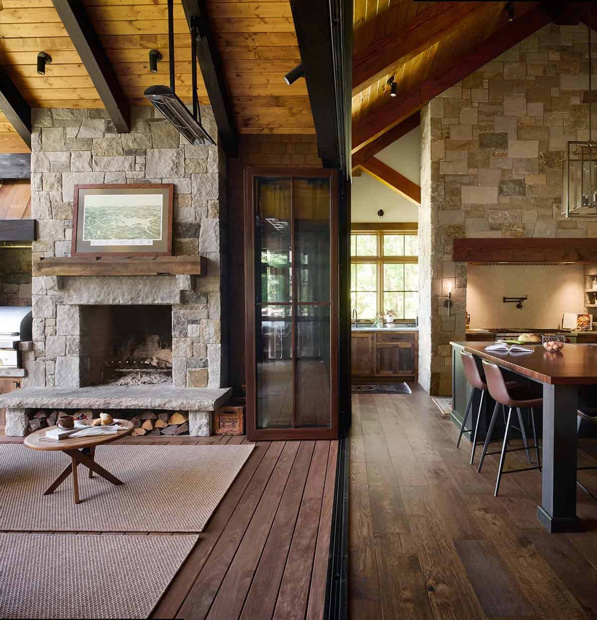 Split view of the screened porch fireplace and grill on the left and the kitchen with a stone range wall and island on the right