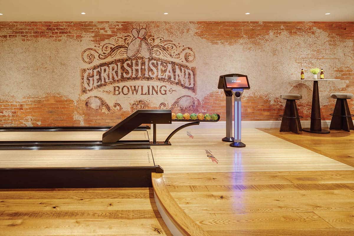 Home two-lane bowling alley with custom-designed wallpaper