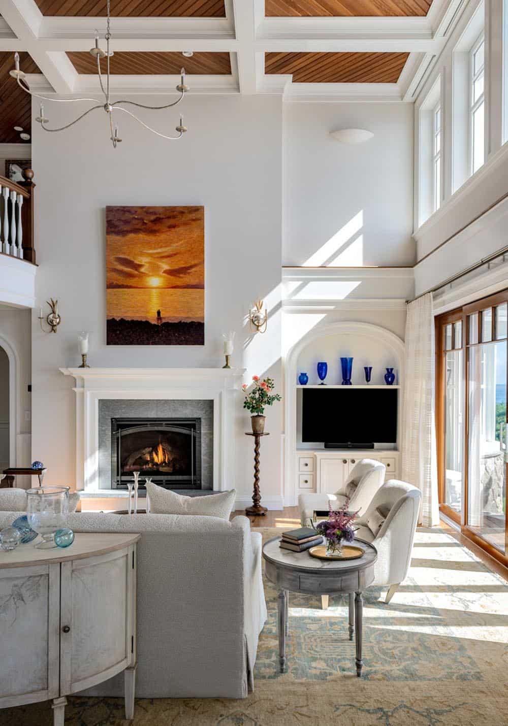 Living room with sunset painting above the fireplace and arched built-in shelf