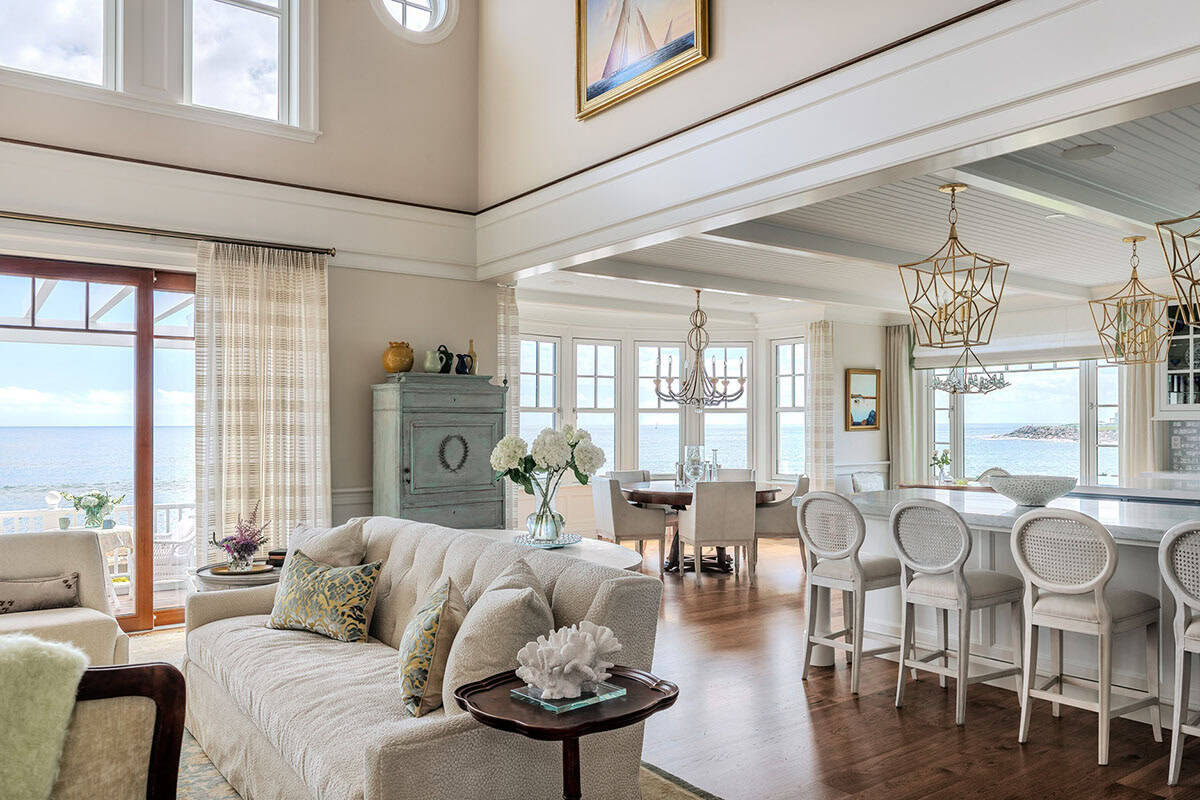 Open-plan living, dining, and kitchen area with ocean views and counter stools