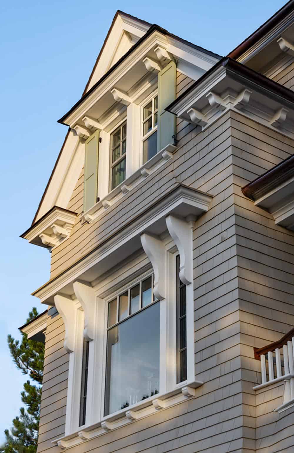 Shingled gable with green shutters, white brackets, and detailed trim